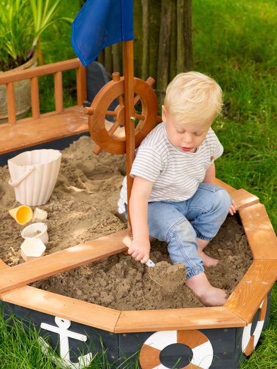 AXI Doris Boot Sandkasten mit Aufbewahrungsbank Anthrazit/Braun – Flagge und Holzsteuerrad – Inklusive Abdeckplane und Bodenplane – 10 Jahre Garantie!